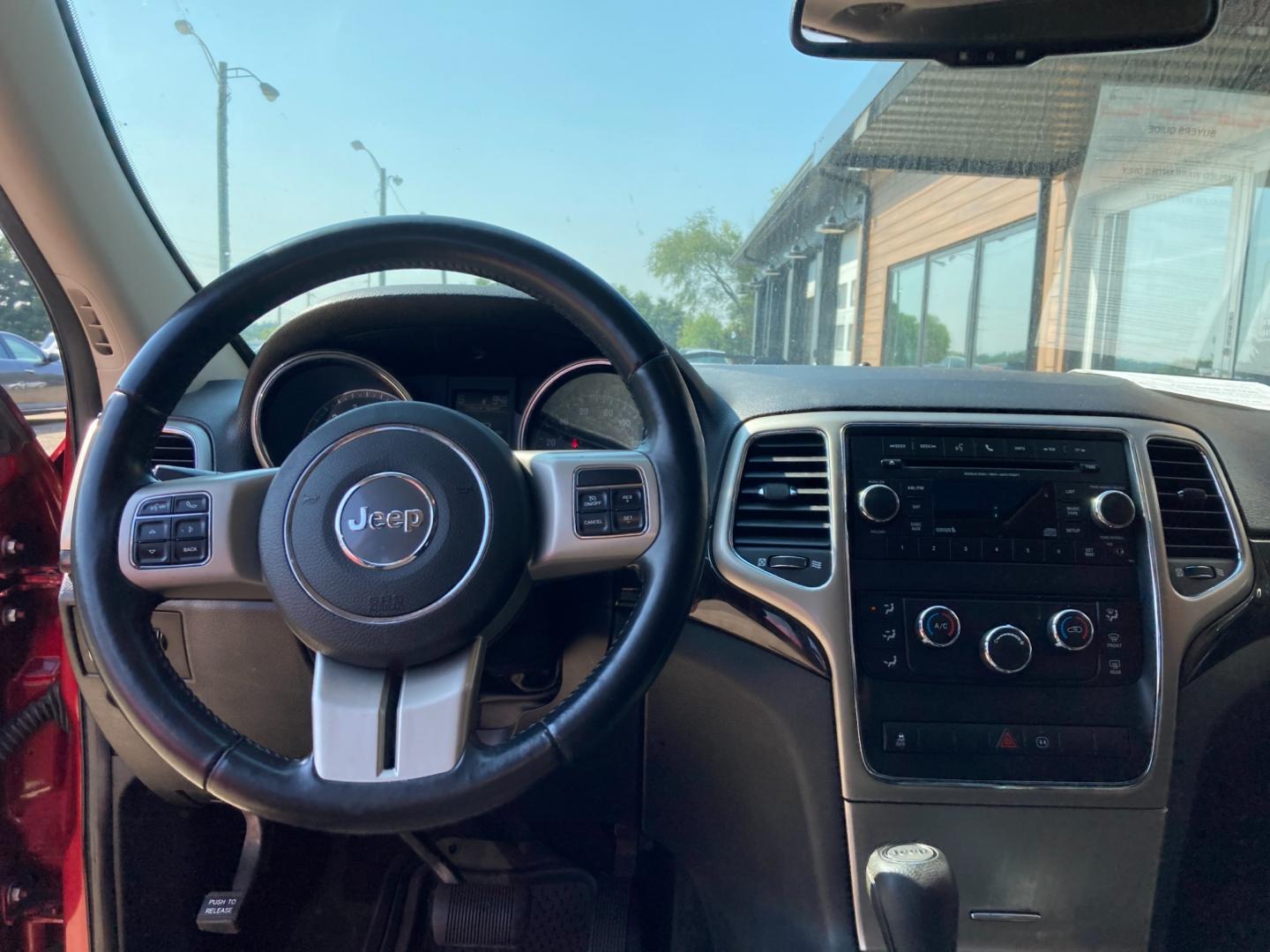 2012 Ruby Red Met Jeep Grand Cherokee Laredo 4WD (1C4RJFAG4CC) with an 3.6L V6 DOHC 24V engine, 5-Speed Automatic transmission, located at 1800 South Ihm Blvd, Freeport, IL, 61032, (815) 232-5543, 42.278645, -89.607994 - Grand Cherokee Laredo 4D SUV 4WD - Photo#7